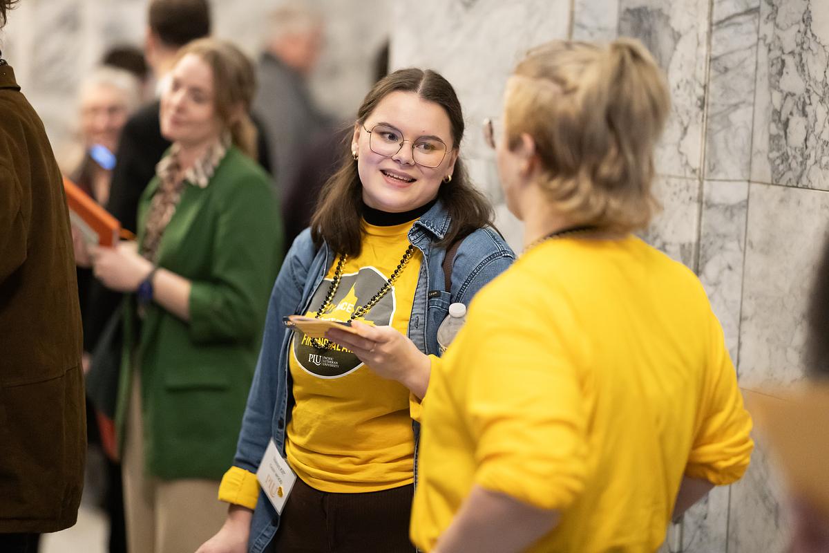 Two students talk inside the Washington State Capitol.