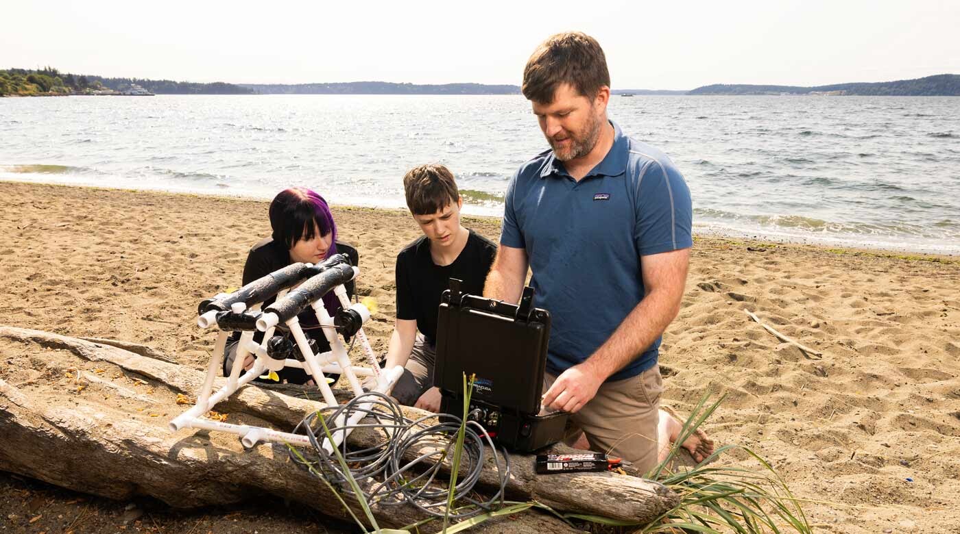 Associate Professor of Computer Science Jeff Caley and his research students, Thursday, July 23, 2026, at Sunnyside Beach Park. Photographed for Resolute. (PLU Photo / Sy Bean)