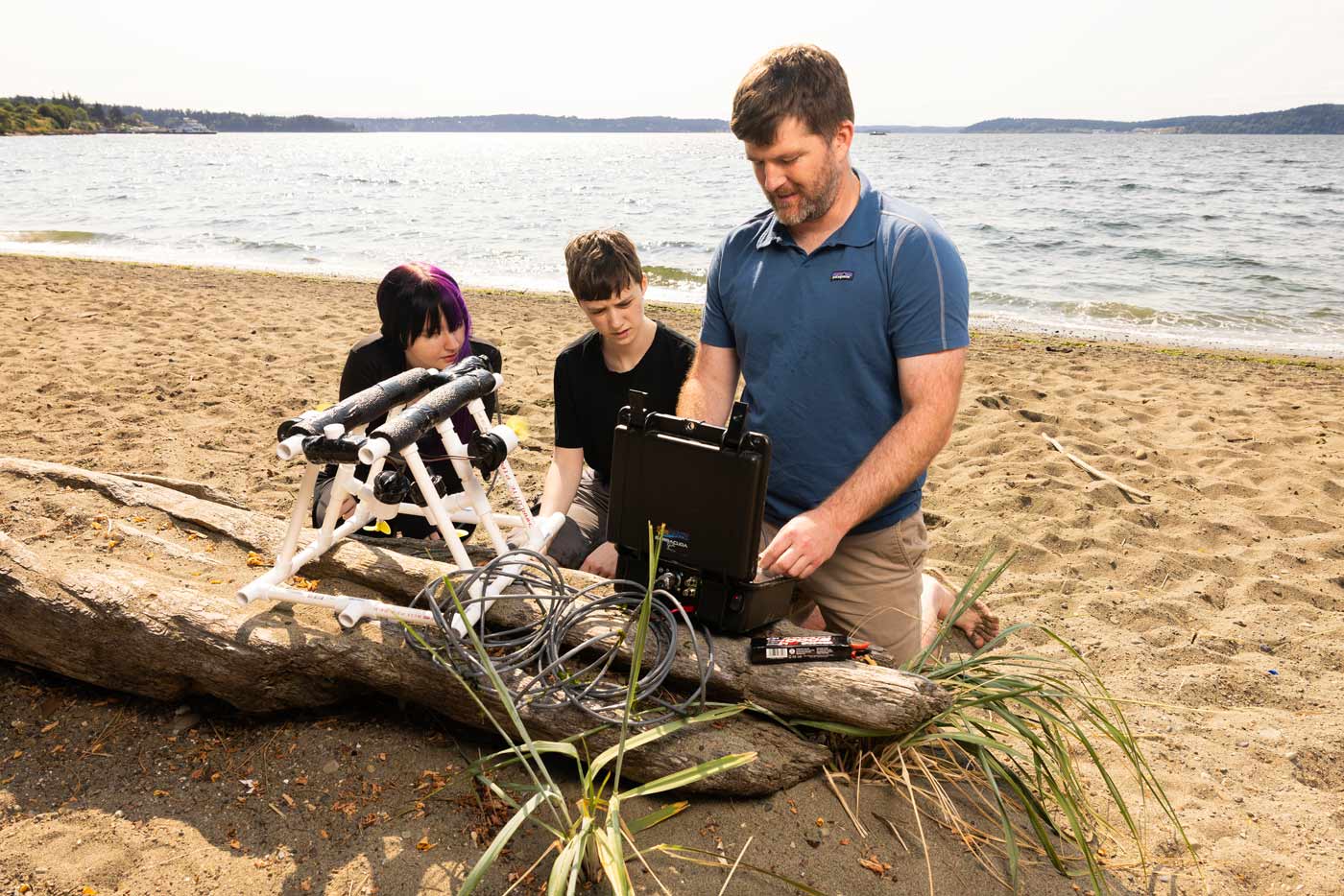 Associate Professor of Computer Science Jeff Caley and his research students, Thursday, July 23, 2026, at Sunnyside Beach Park. Photographed for Resolute. (PLU Photo / Sy Bean)