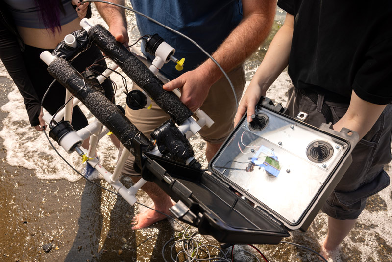 Associate Professor of Computer Science Jeff Caley and his research students, Thursday, July 23, 2026, at Sunnyside Beach Park. Photographed for Resolute. (PLU Photo / Sy Bean) Associate Professor of Computer Science Jeff Caley and his research students, Thursday, July 23, 2026, at Sunnyside Beach Park. Photographed for Resolute. (PLU Photo / Sy Bean)
