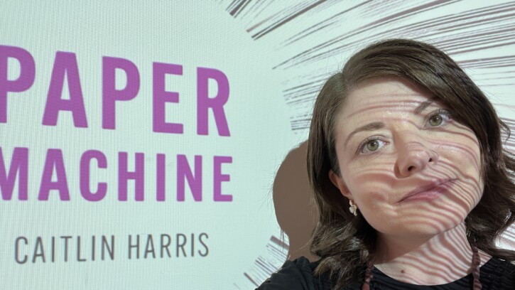 Woman standing in front of a slide projection.