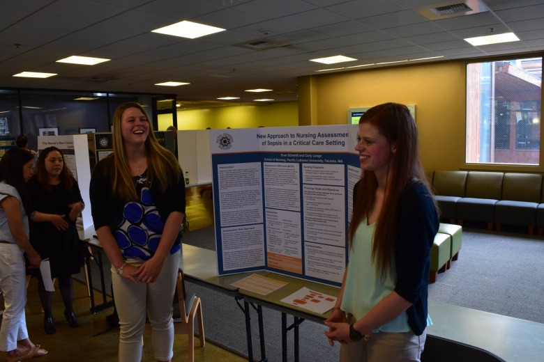 Capstone Poster Presentations for Spring 2016 (Photo: Kate Prigge, SoN) students talking to others about their research