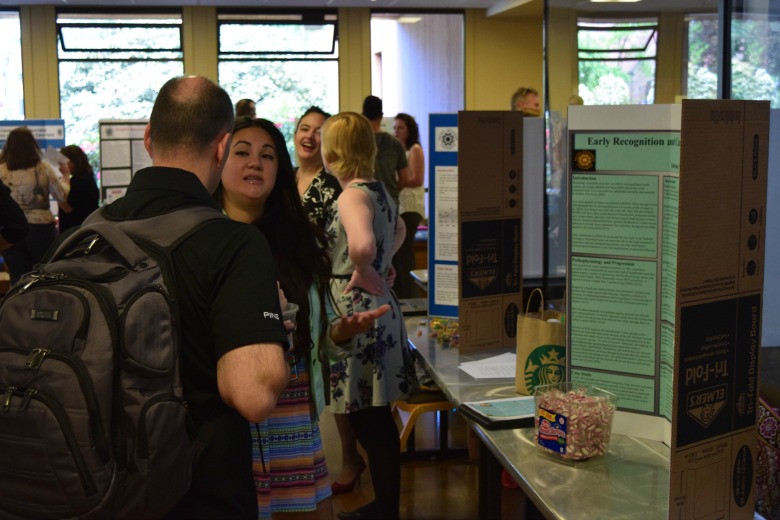 Capstone Poster Presentations for Spring 2016 (Photo: Kate Prigge, SoN) students talking to others about their research