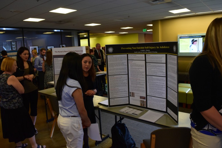 Capstone Poster Presentations for Spring 2016 (Photo: Kate Prigge, SoN) students talking to others about their research