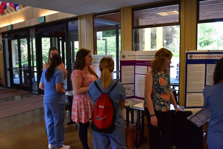 Capstone Poster Presentations for Spring 2016 (Photo: Kate Prigge, SoN) students talking to others about their research