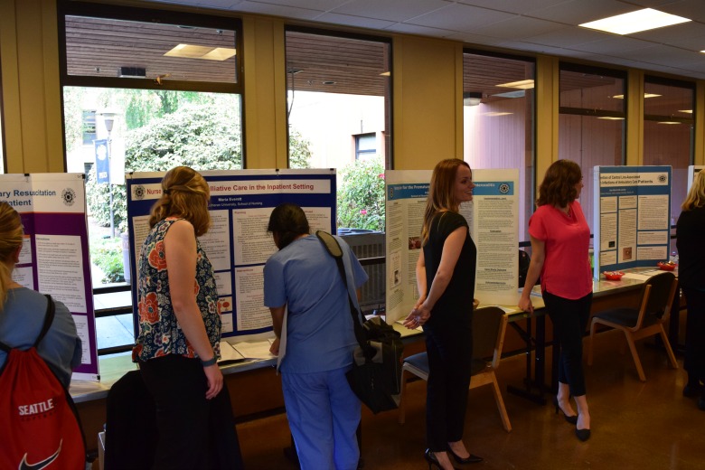 Capstone Poster Presentations for Spring 2016 (Photo: Kate Prigge, SoN) students talking to others about their research