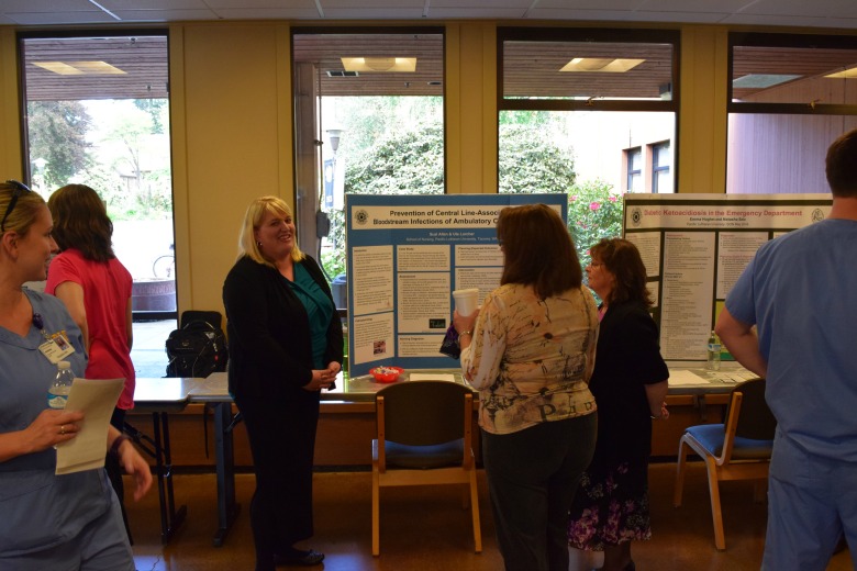 Capstone Poster Presentations for Spring 2016 (Photo: Kate Prigge, SoN) students talking to others about their research