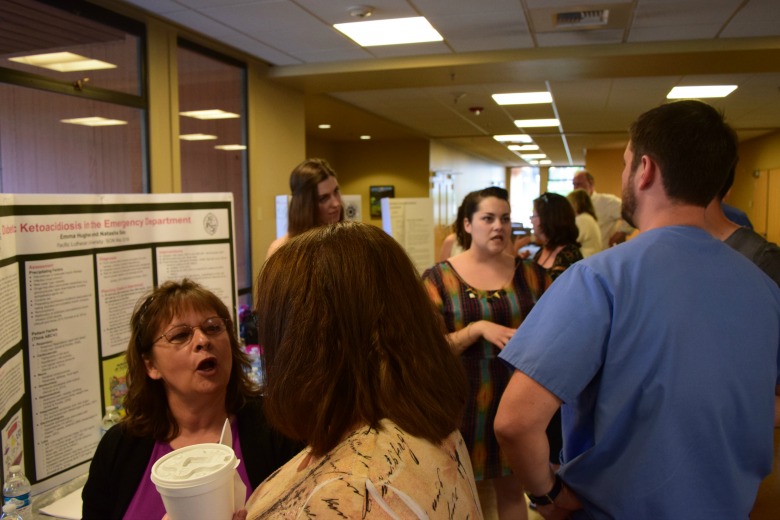 Capstone Poster Presentations for Spring 2016 (Photo: Kate Prigge, SoN) students talking to others about their research