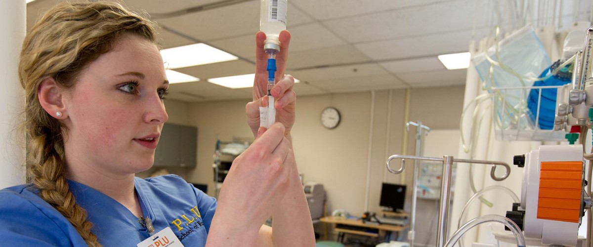 Haley Urdahl '15 nursing student working with an IV