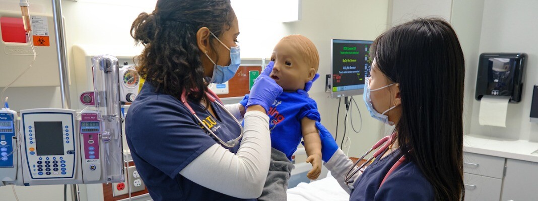 Two students with a sim baby
