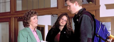 Professor Christine Hansvick talking to a couple of students