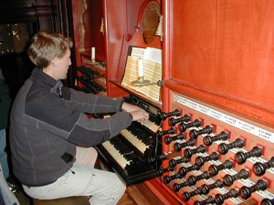plu-student PLU Student playing an organ
