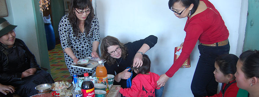 Bonnie Nelson '08 (Mongolia 2011-2013) participating in a traditional hair cutting ceremony for the young daughter of her friend and fellow teacher