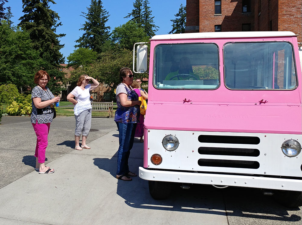 Staff at the ice cream truck picking out their ice cream treats