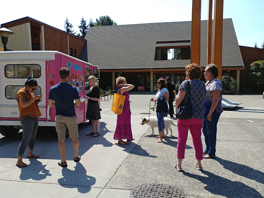 Staff at the ice cream truck picking out their ice cream treats