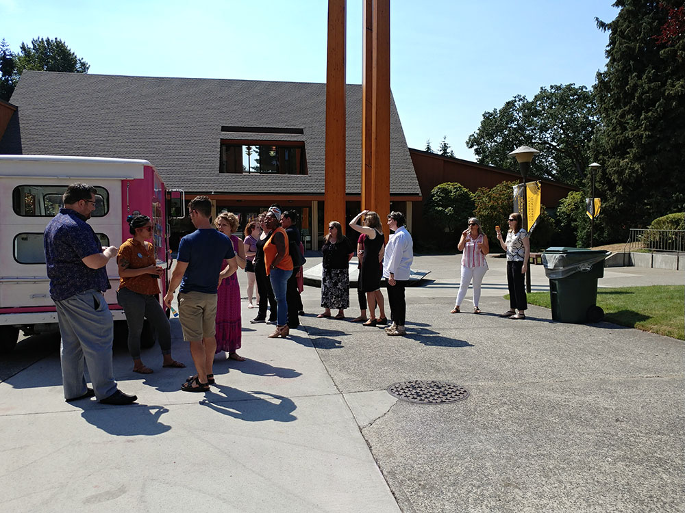 Staff at the ice cream truck picking out their ice cream treats