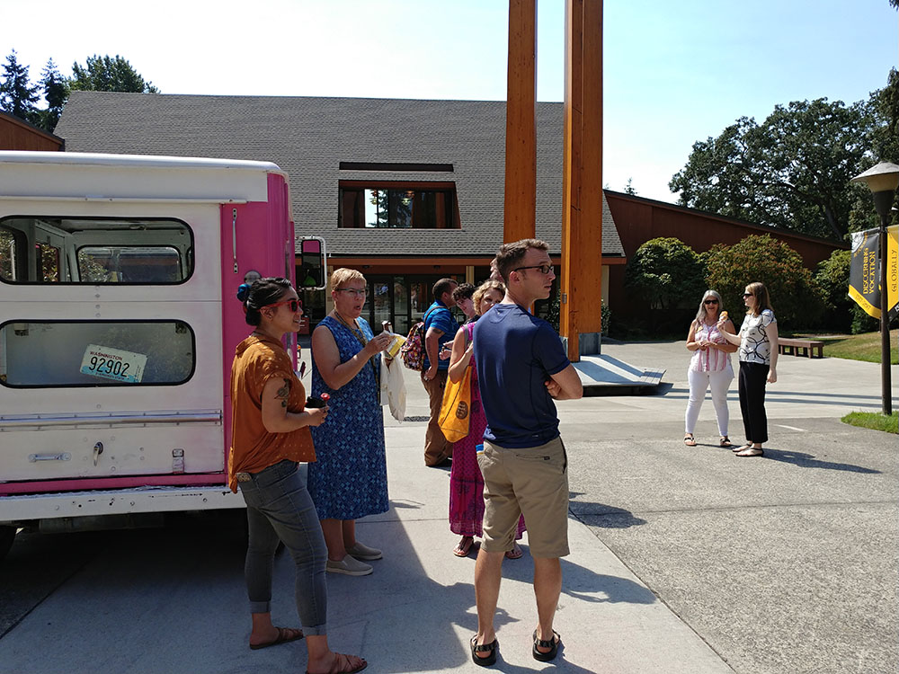 Staff at the ice cream truck picking out their ice cream treats