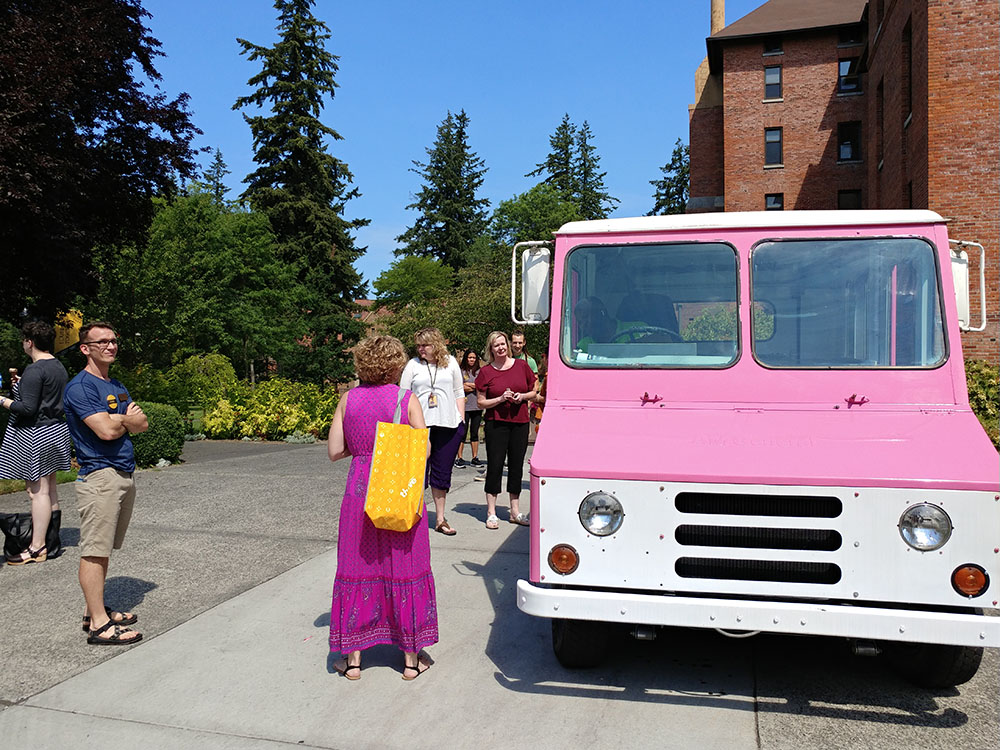 Staff at the ice cream truck picking out their ice cream treats