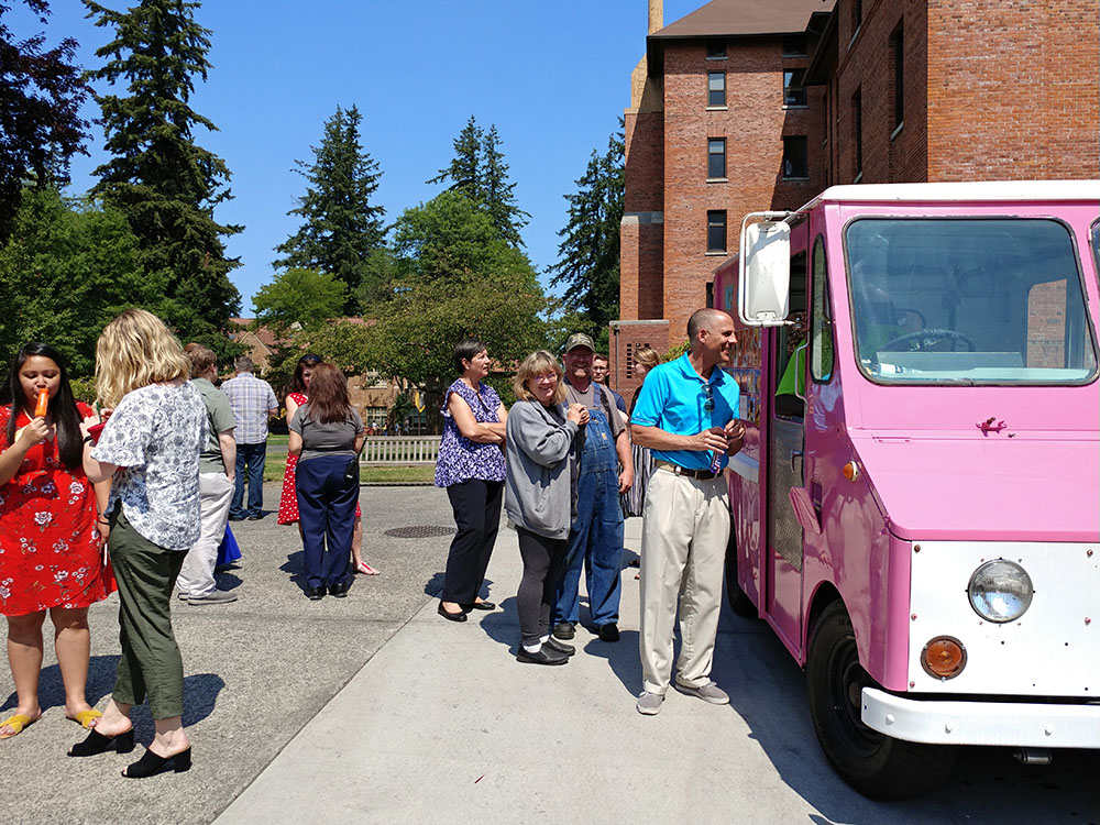 Staff at the ice cream truck picking out their ice cream treats