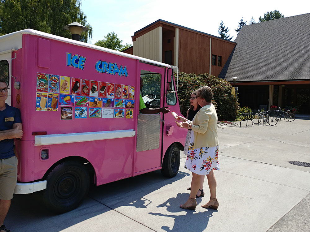 Staff at the ice cream truck picking out their ice cream treats