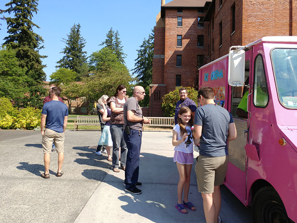 Staff at the ice cream truck picking out their ice cream treats