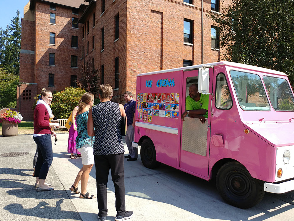 Staff at the ice cream truck picking out their ice cream treats