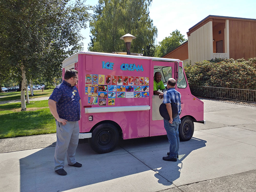 Staff at the ice cream truck picking out their ice cream treats