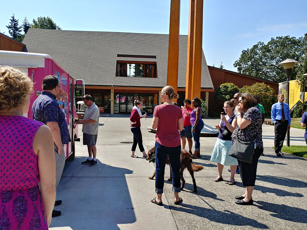 Staff at the ice cream truck picking out their ice cream treats