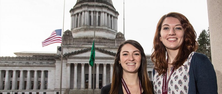 2 students standing in front of the capitol