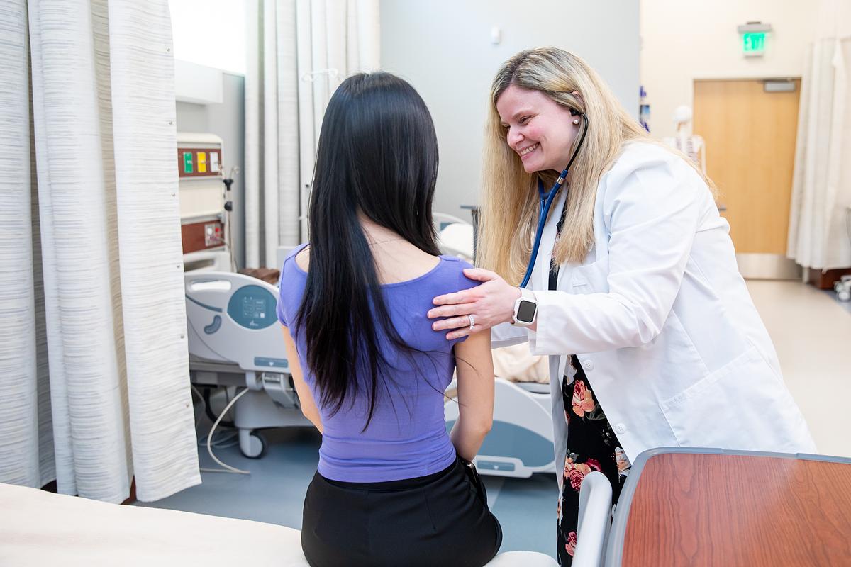 Doctor examining patient in medical office.