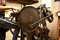 Typesetting 089 PLU student and Elliot Press assistant, Caitlin Harris, prints at job for Campus Ministry at the Elliot Press Studios in Parkland.