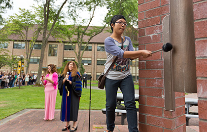 Student Strikes Centennial Bell