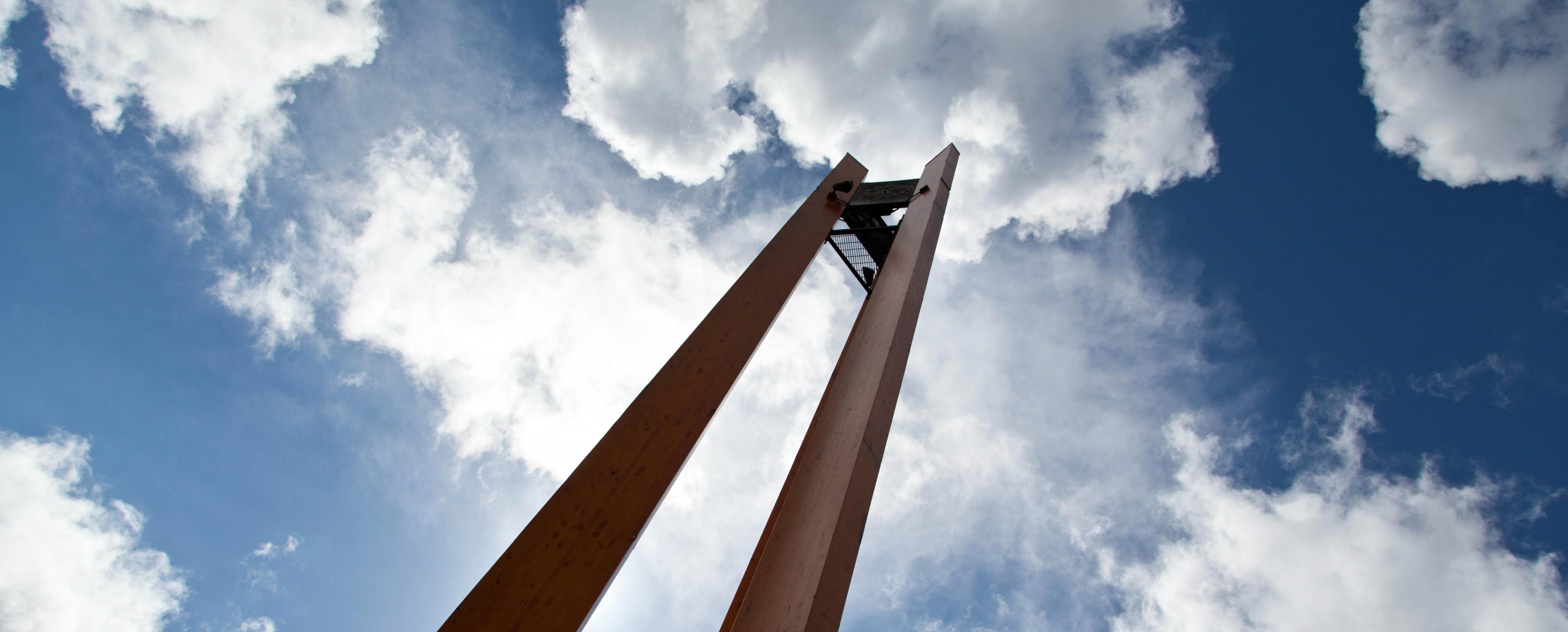 Looking up at the clock tower on a cloudy day