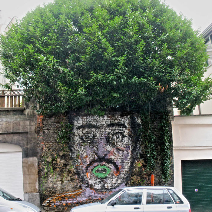 photo by Jared Polin - painted person on wall with a tree above as hair