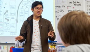 PLU student leading a science class at an elementary school.