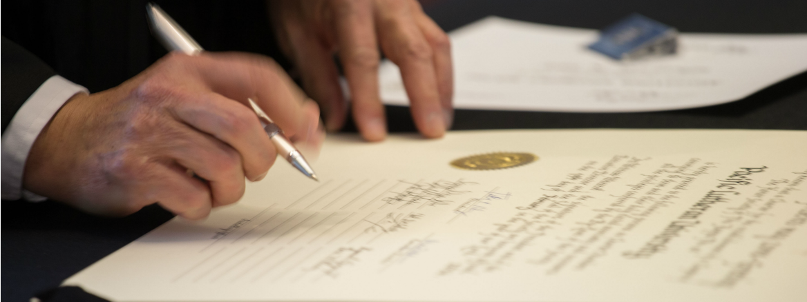 Phi Kappa Phi Chapter instillation ceremony at PLU on Friday, Feb. 19, 2016. (Photo: John Froschauer/PLU) Signing the charter.