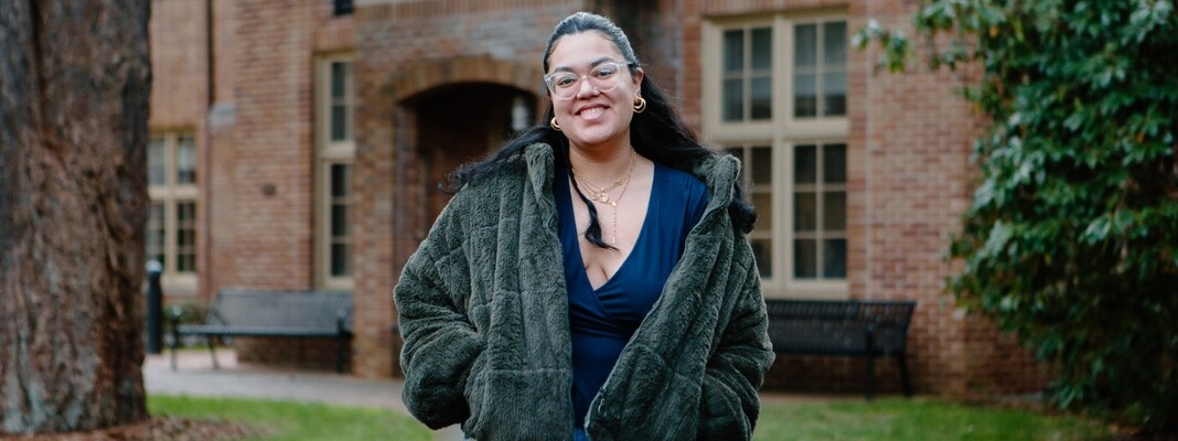 Stephanie Aparicio Zambrano in front of Harstad Hall