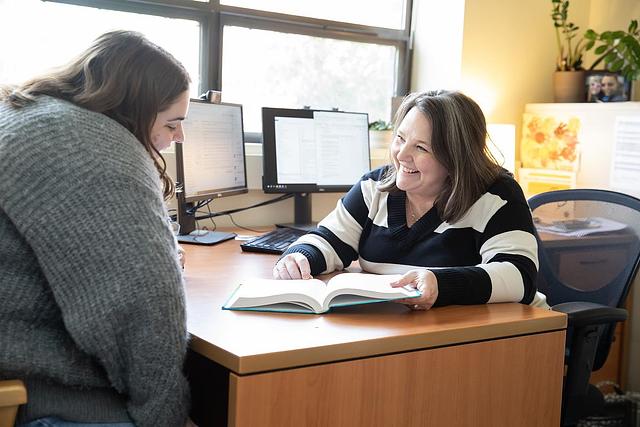Tiffany Artime meeting with a student.