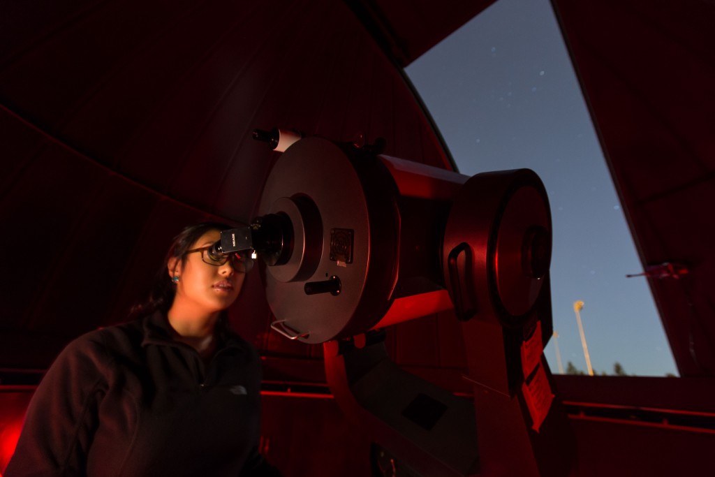 Kimberly Belmes '18, adjusts the telescope on Saturn for viewers during the Tacoma Astronomical Society and the Physics Dept. opening the Keck observatory for guest to look at the night sky after the Jazz Under the Stars concert at PLU, Thursday, Aug. 11, 2016.