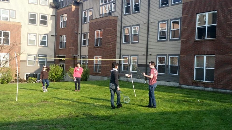 Students playing badminton on South Hall's lawn.