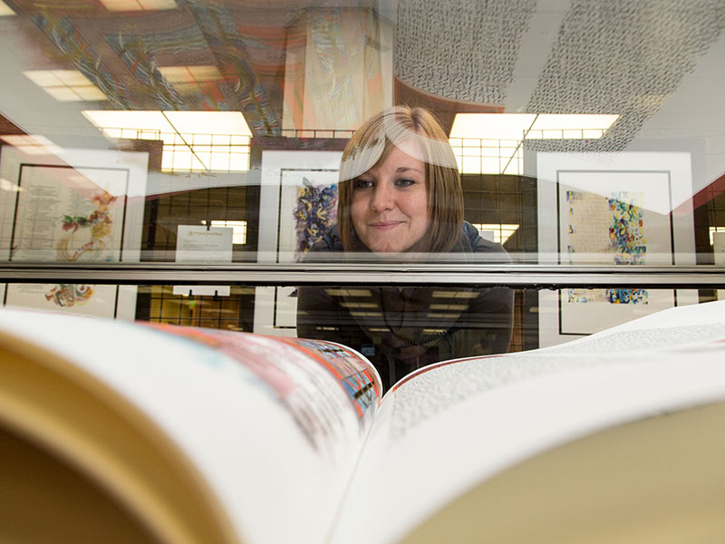 Kari Plog looking at The Saint John's Bible at PLU