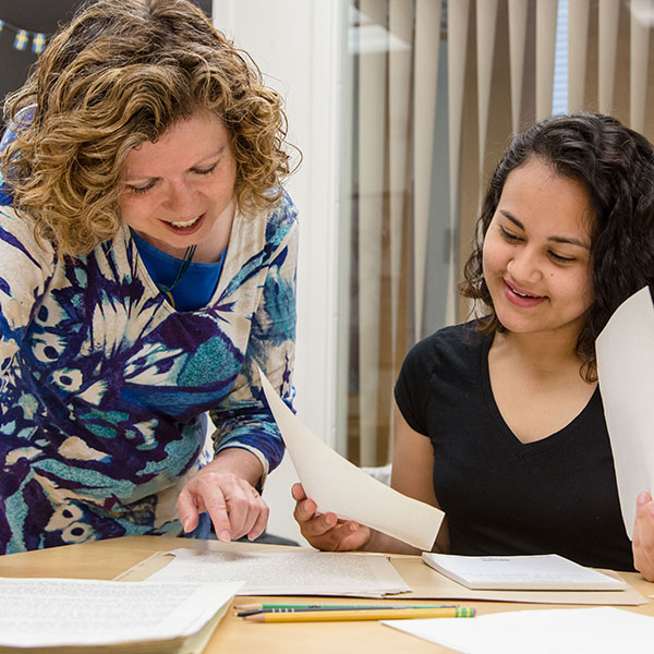 Prof. Gina Hames and Sandra Estrada work in the library at PLU