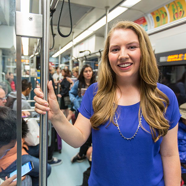 Anna Jessen standing on a bus holding the railing