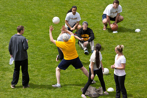 PLU students playing sports on the grass