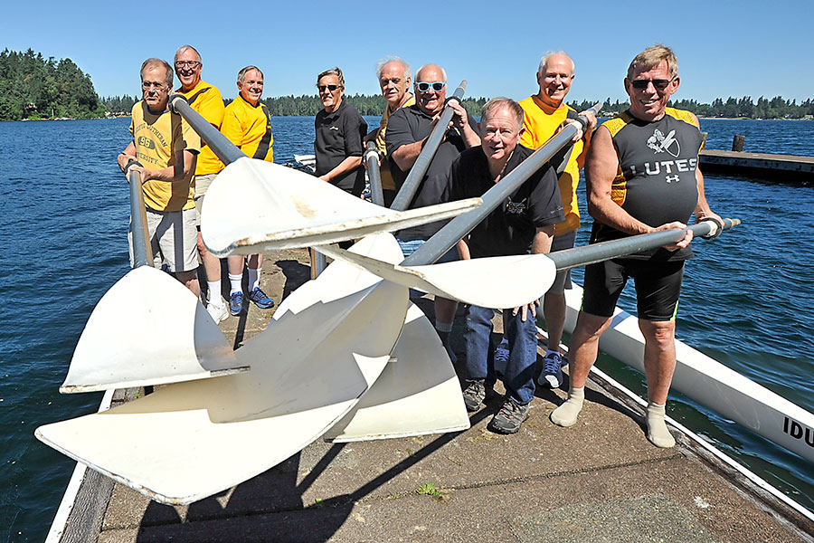 PLU crew 50th reunion and holding oars towards the camera