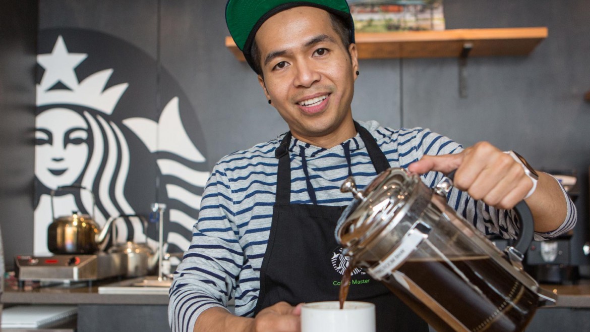 Hansel Doan pouring a cup of coffee at Starbucks