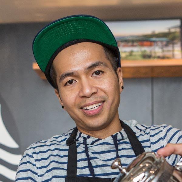 Hansel Doan pouring a cup of coffee at Starbucks