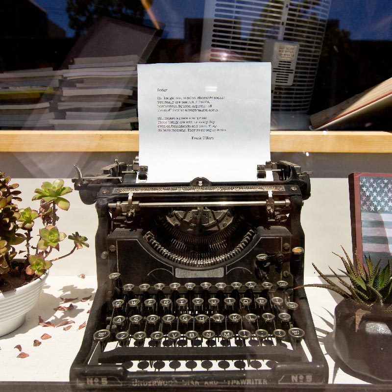 A typewriter with a poem written on a piece of paper