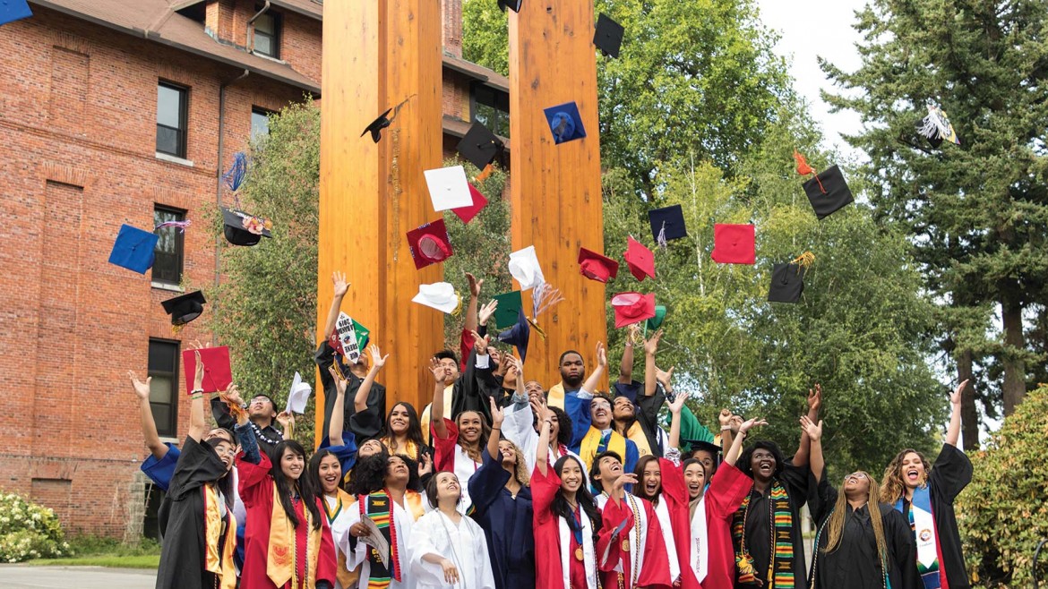 Recent Palmer Scholar's celebrating by tossing their hats into the air