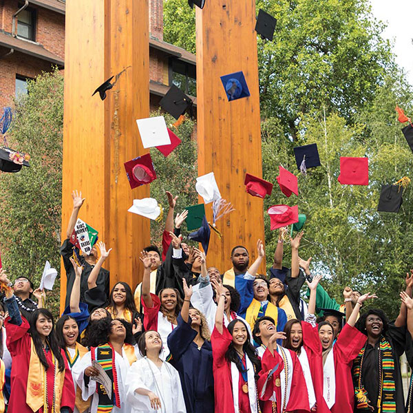 Recent Palmer Scholar's celebrating by tossing their hats into the air